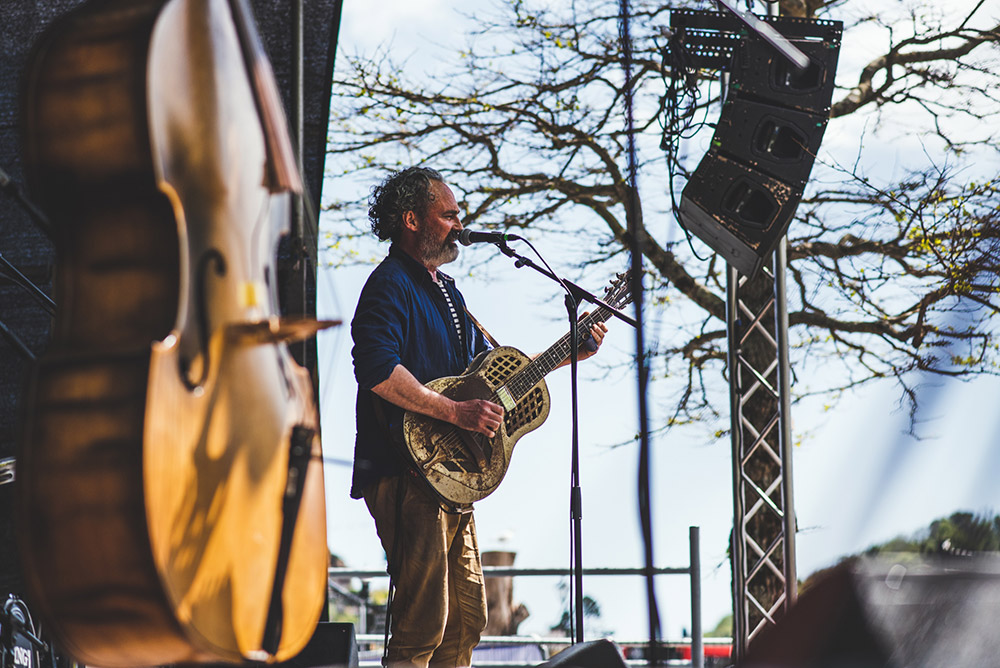 Event Photography: In this picture of Kingsize Slim taken for Dart Music Festival the instrument in the foreground adds another layer of interest. Copyright: Claire Gillo