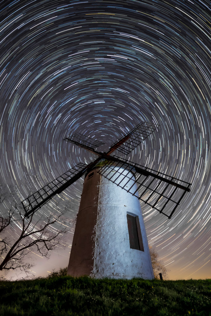 Ashton Windmill with full circle star trails centered at the middle of the windmill's spades, astrophotography