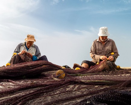 fishermen fixing their fishing nets